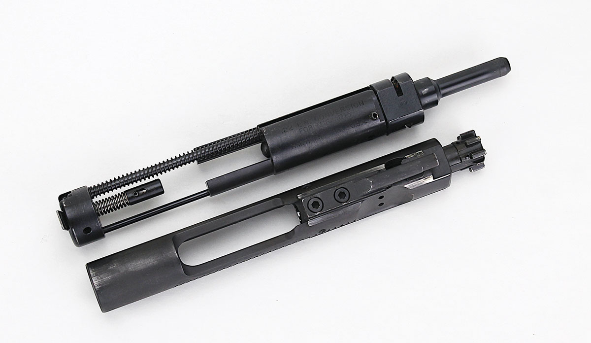 All such conversion kits replace the AR’s BCG (bottom) with a BCG that  handles the 22 Long Rifle cartridge and bypasses the AR-15’s gas system  to become a blowback action (top).